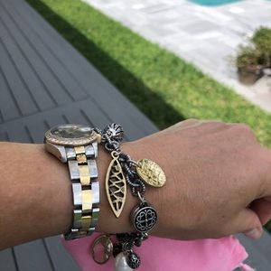 Mixed metal charm bracelet with magnetic closure